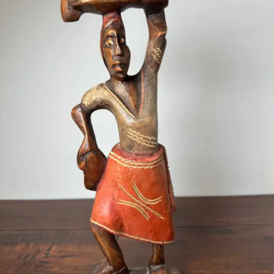 Hand-Carved Wooden Sculpture of Figure in Red Skirt - product image 1